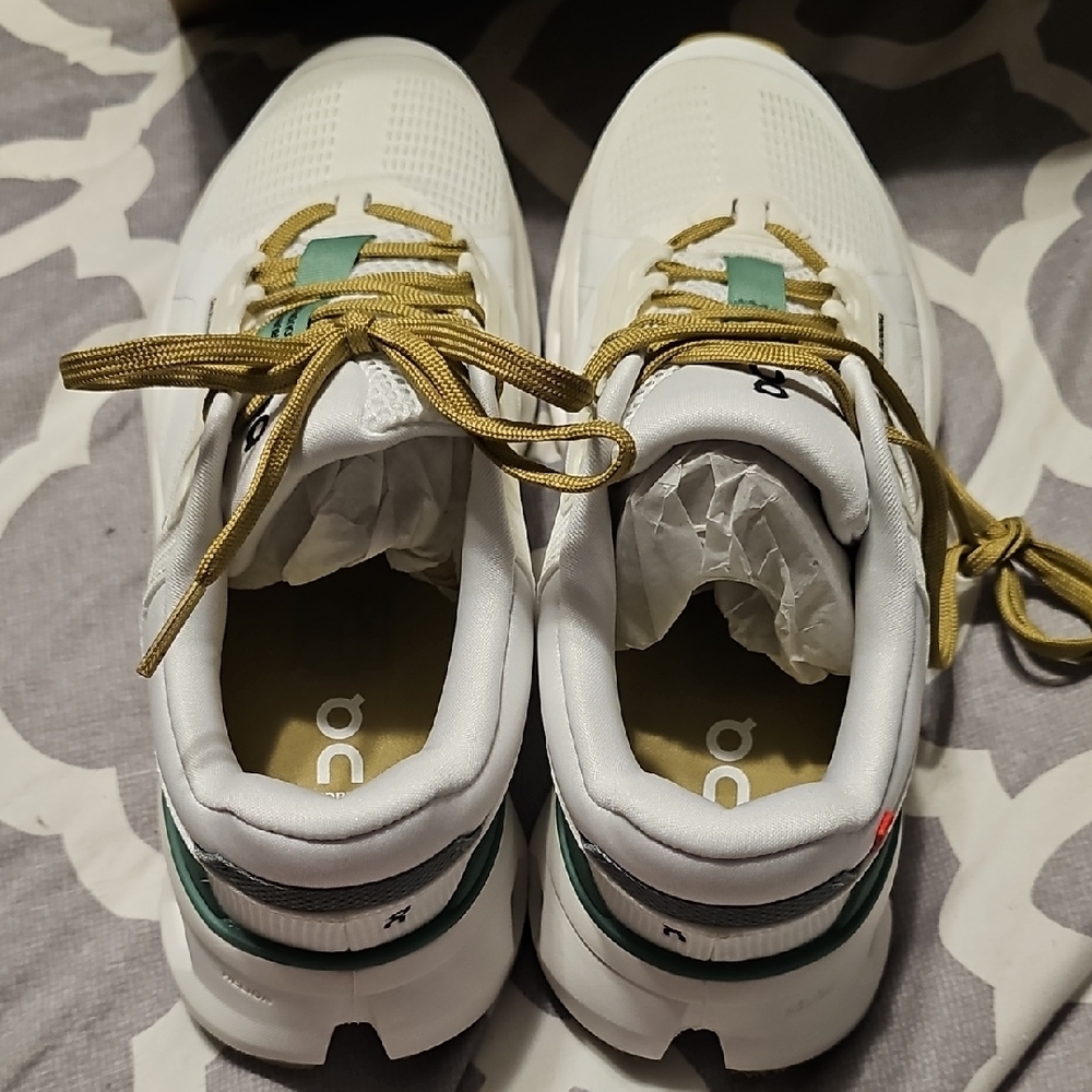On Running White and Gold Shoes